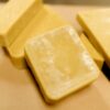 A couple of pieces of cheese sitting on top of a table